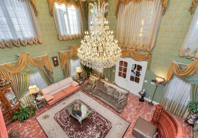 a living room with furniture and a chandelier