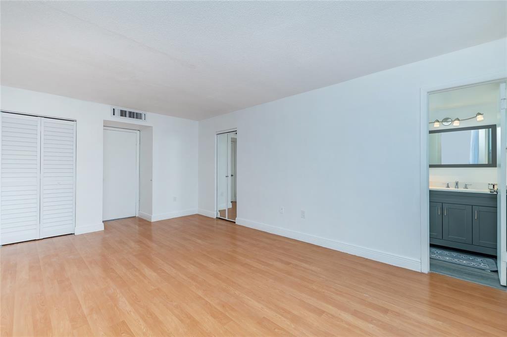 1101 Northeast 191st Street, Unit H301 Miami, FL 33179 - Photo 11 of 18 a view of an empty room with a kitchen and a window