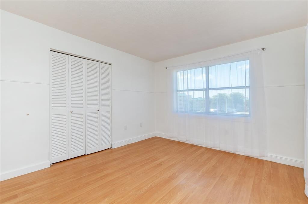 1101 Northeast 191st Street, Unit H301 Miami, FL 33179 - Photo 13 of 18 an empty room with a window