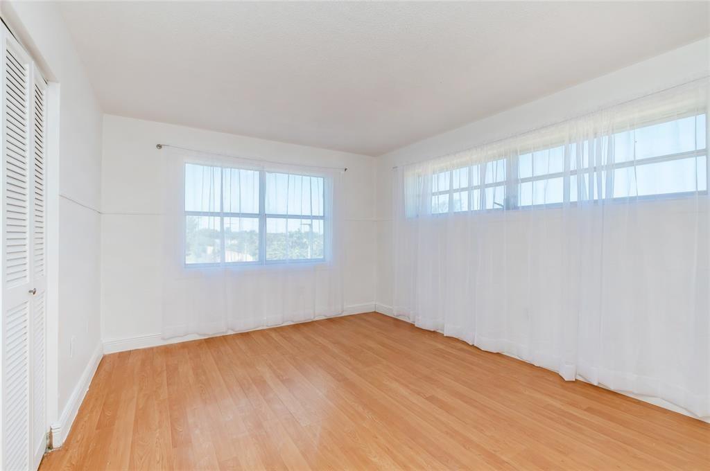 1101 Northeast 191st Street, Unit H301 Miami, FL 33179 - Photo 14 of 18 an empty room with a window