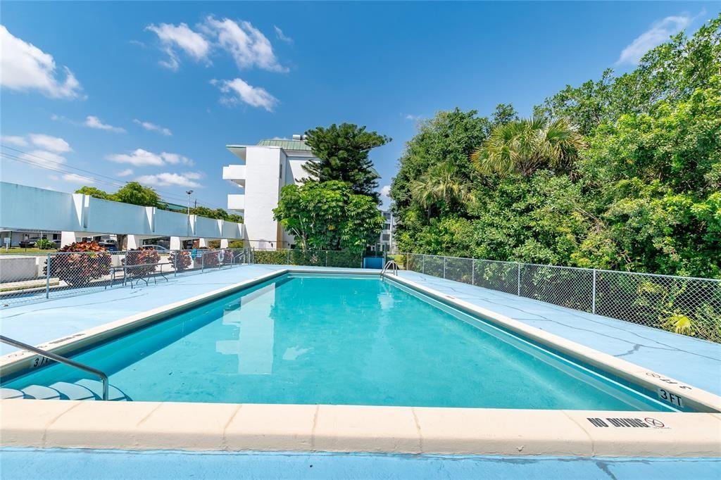 1101 Northeast 191st Street, Unit H301 Miami, FL 33179 - Photo 17 of 18 a view of swimming pool from a balcony