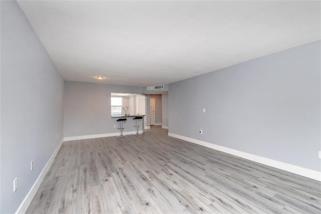 1101 Northeast 191st Street, Unit H301 Miami, FL 33179 - Photo 7 of 18 a view of empty room with wooden floor