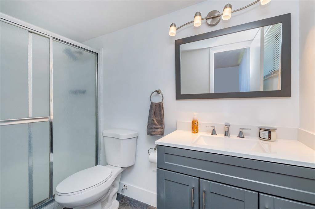 1101 Northeast 191st Street, Unit H301 Miami, FL 33179 - Photo 10 of 18 a bathroom with a toilet sink and mirror