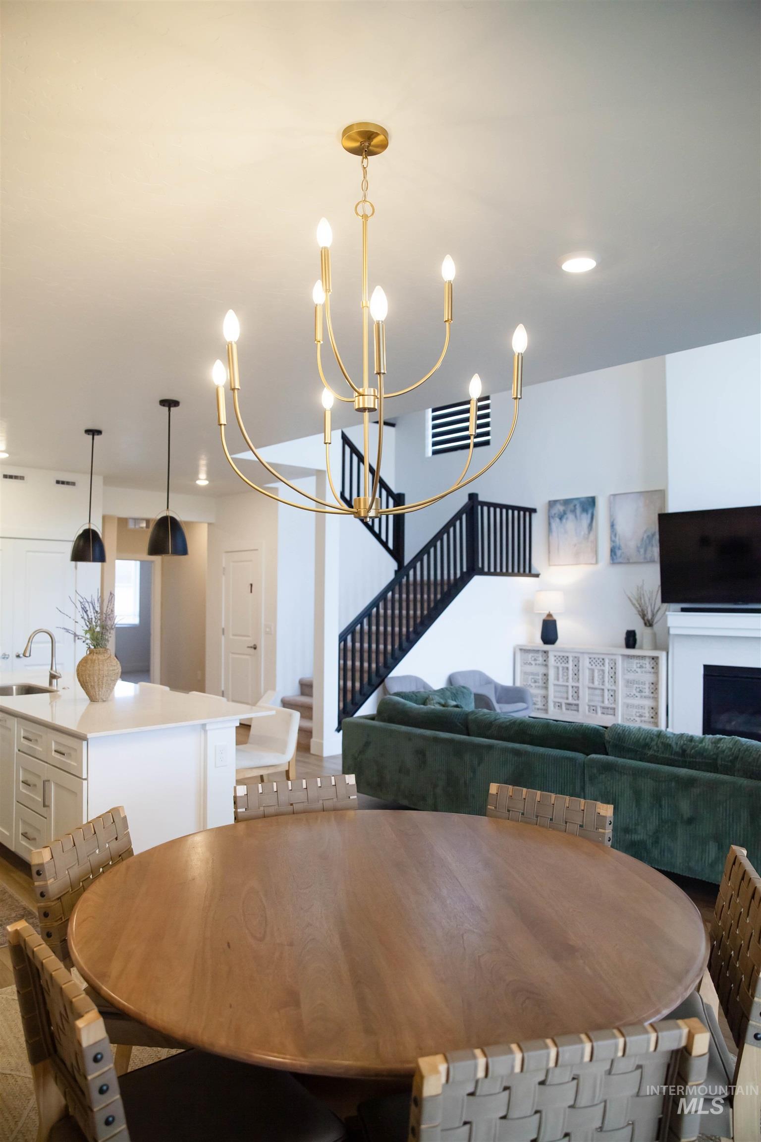 151 Insight Court Middleton, ID 83644 - Photo 11 of 35 Dining space with hanging lights and a fireplace