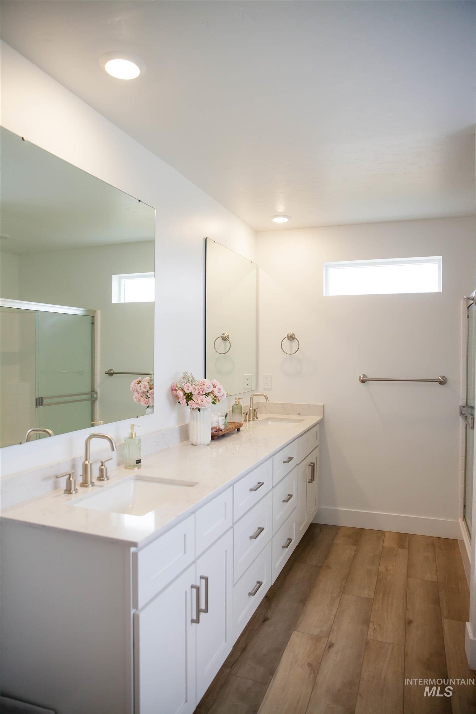 151 Insight Court Middleton, ID 83644 - Photo 21 of 35 Full bathroom featuring a shower stall, double vanity, dark wood-style floors, and recessed lighting