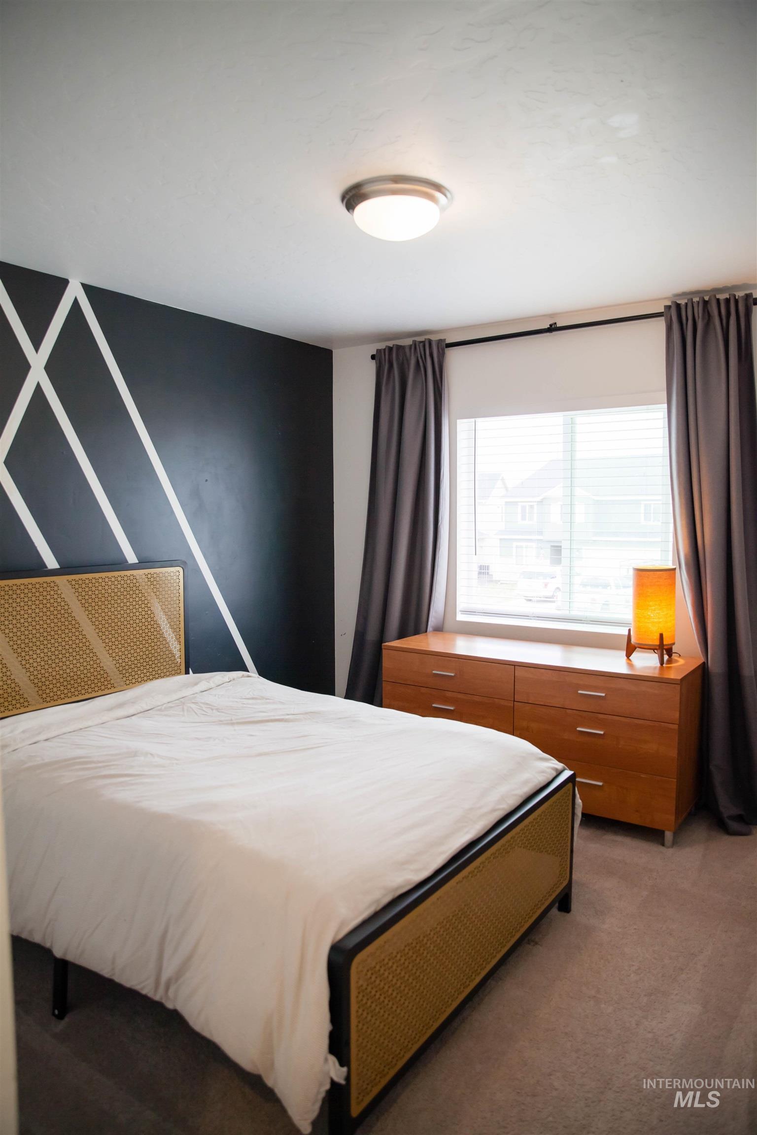 151 Insight Court Middleton, ID 83644 - Photo 25 of 35 Bedroom with dark colored carpet and an accent wall