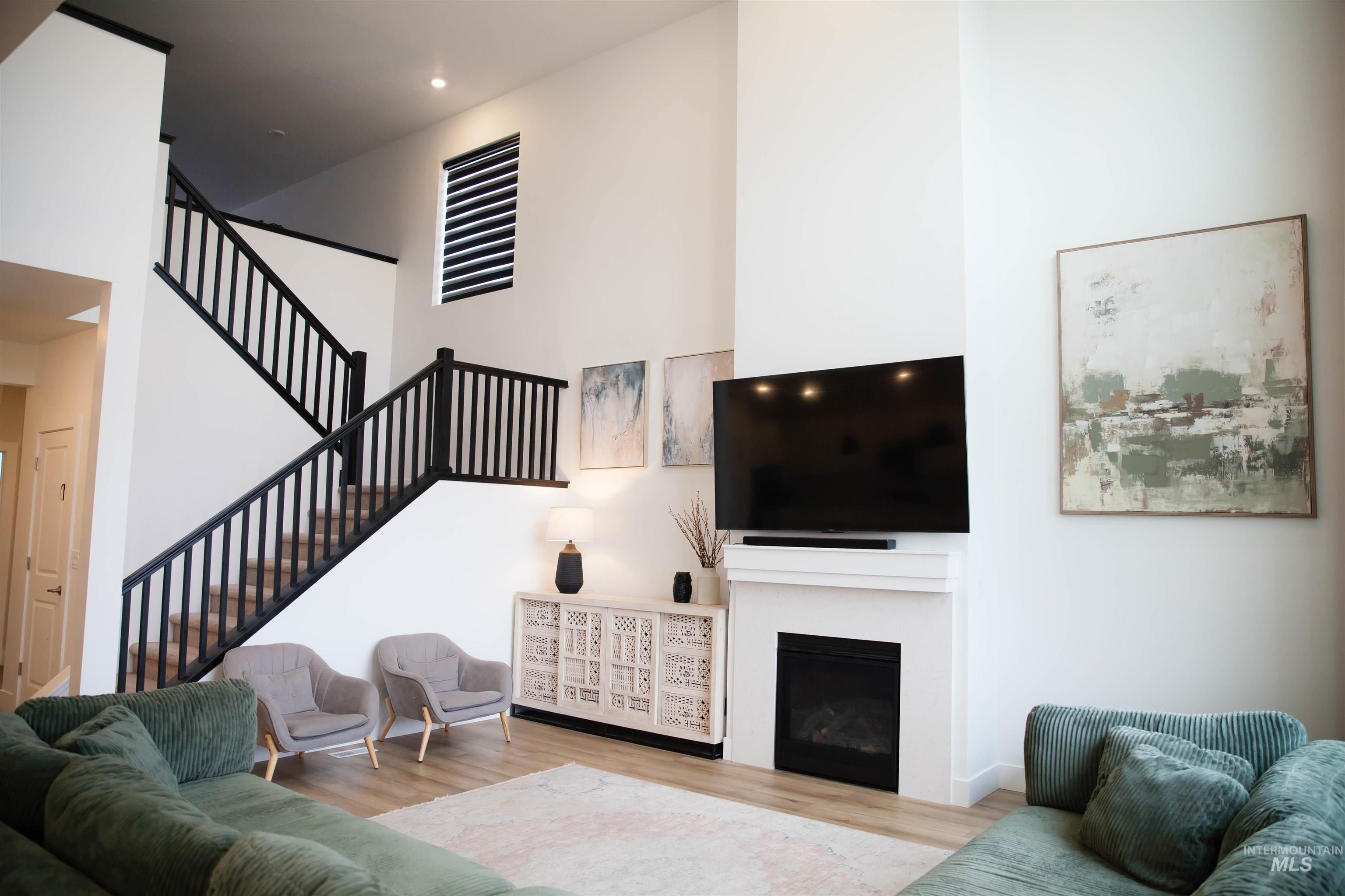 151 Insight Court Middleton, ID 83644 - Photo 5 of 35 Living area with wood finished floors, a fireplace, and a high ceiling