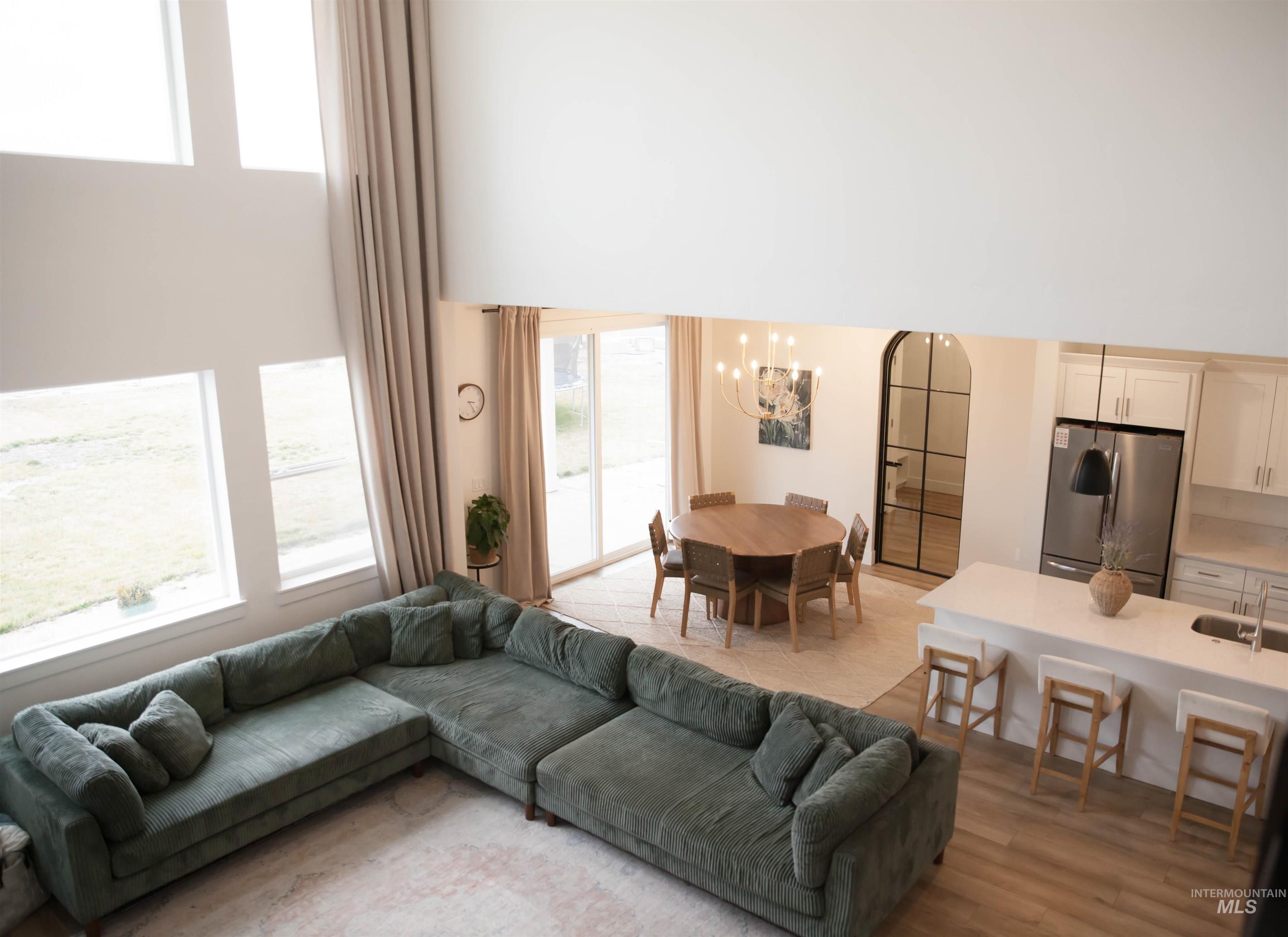 151 Insight Court Middleton, ID 83644 - Photo 6 of 35 Living room featuring suspended lighting and a high ceiling