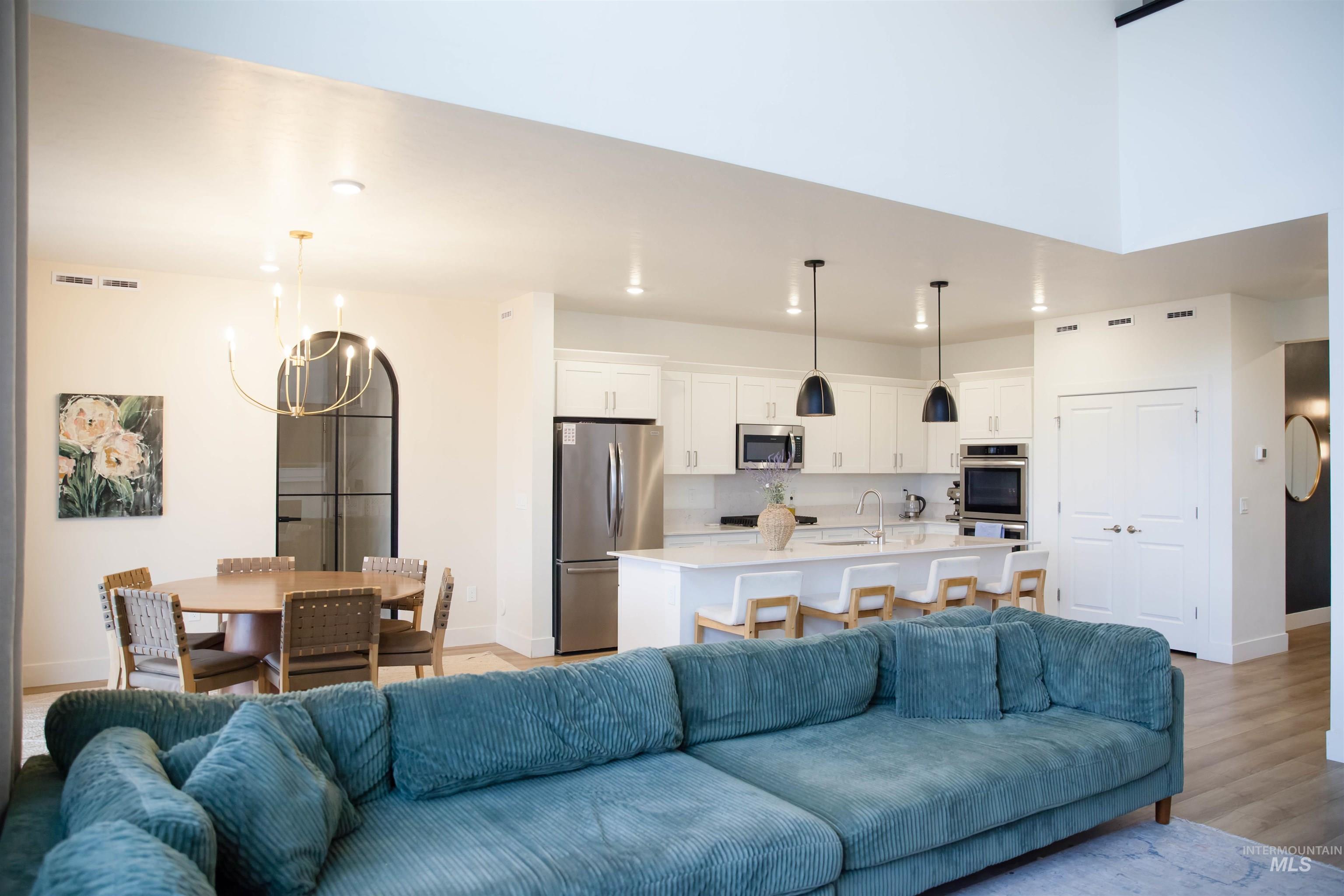151 Insight Court Middleton, ID 83644 - Photo 7 of 35 Living room featuring light wood-type flooring and a chandelier
