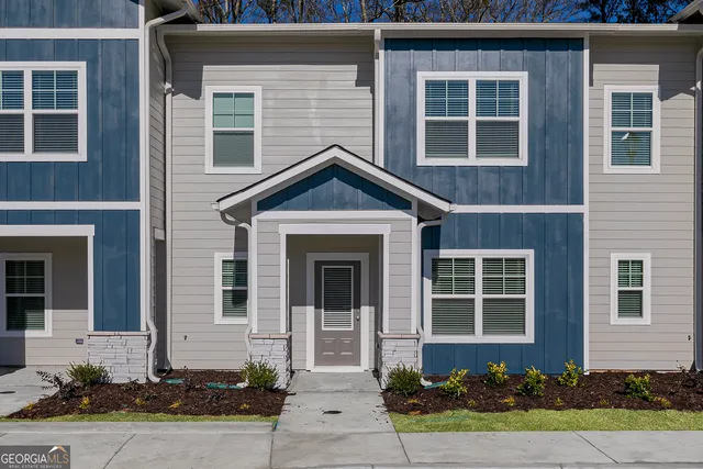 a front view of a house with garden
