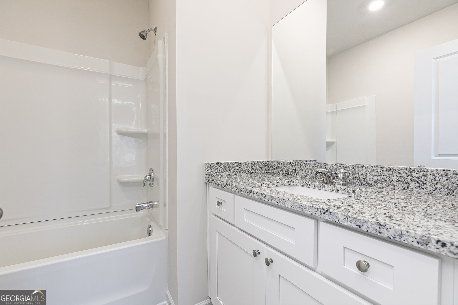 226 Rooker Drive LaGrange, GA 30241 - Photo 13 of 15 a bathroom with a granite countertop sink and white tub