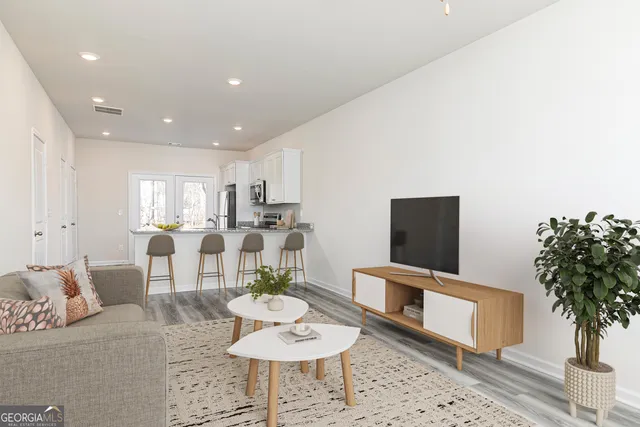 a living room with furniture and a potted plant