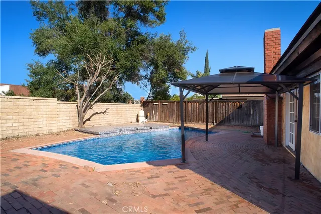 a view of a backyard with a large tree