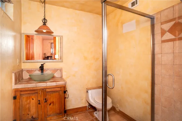 a bathroom with a sink a mirror and a shower