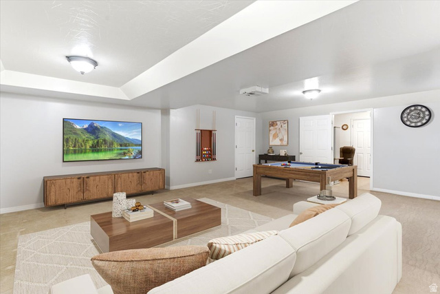 72 Canal Bank Road Garland, UT 84312 - Photo 20 of 40 Spacious entertainment area featuring tray ceilings with flush-mount lighting, recessed projector, and a wood-finish media console