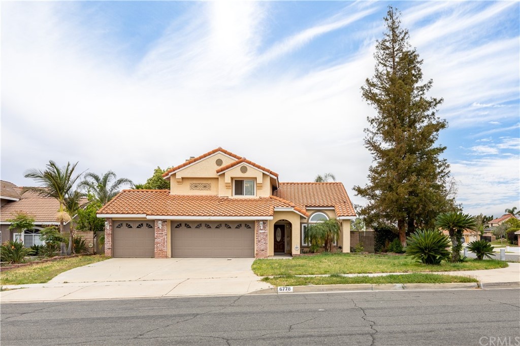 6778 Trinity Place Rancho Cucamonga, CA 91701 - Photo 1 of 1 a front view of a house with a yard and garage