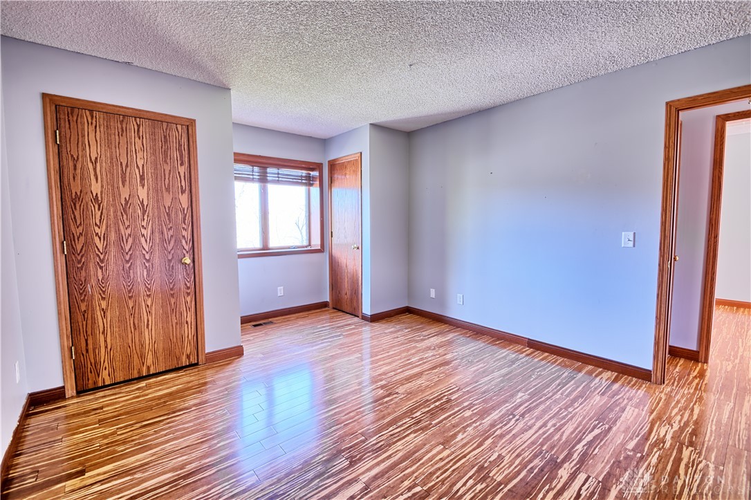 8711 Nicole Lane Springboro, OH 45066 - Photo 58 of 87 This airy room features warm wood flooring and ample natural light, creating an inviting atmosphere.