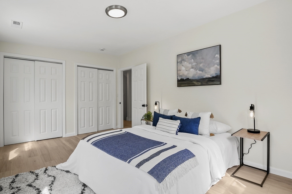 128 Dana Road Oxford, MA 01540 - Photo 12 of 23 a bedroom with a bed and a chandelier