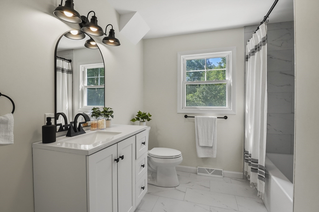 128 Dana Road Oxford, MA 01540 - Photo 14 of 23 a bathroom with a toilet sink and mirror