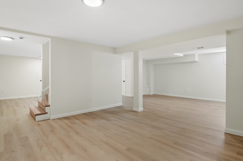 128 Dana Road Oxford, MA 01540 - Photo 17 of 23 an empty room with wooden floor and windows