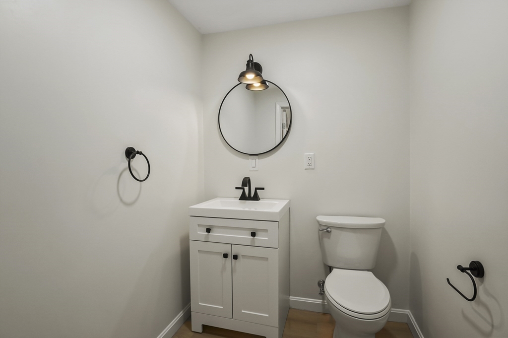 128 Dana Road Oxford, MA 01540 - Photo 18 of 23 a bathroom with a toilet sink vanity and mirror