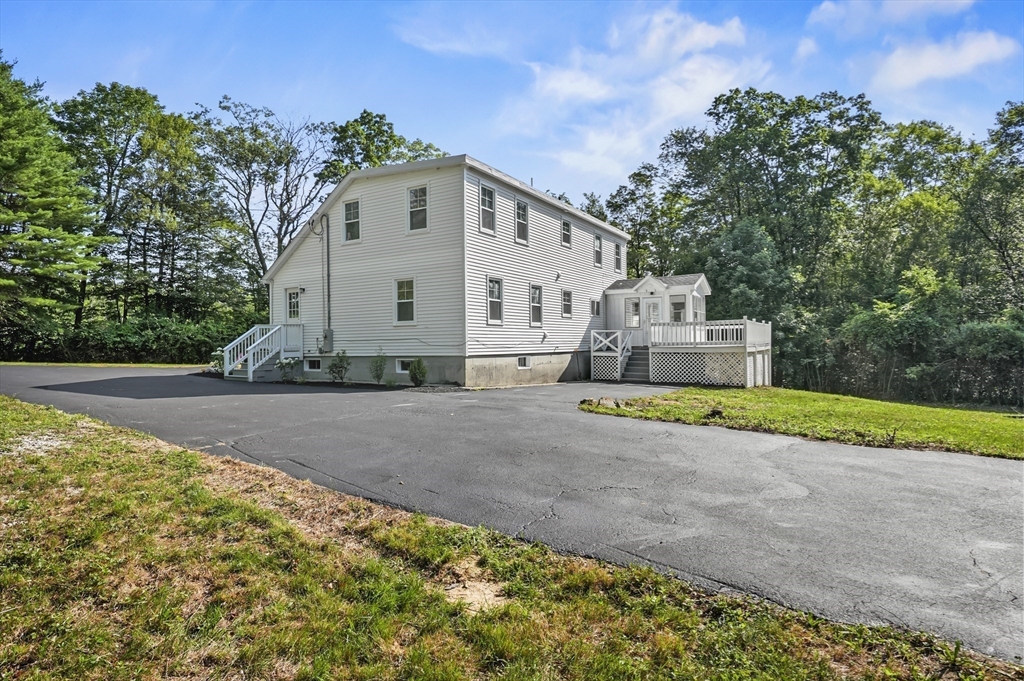 128 Dana Road Oxford, MA 01540 - Photo 2 of 23 a view of a white house with a yard