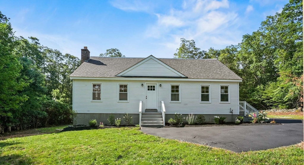 128 Dana Road Oxford, MA 01540 - Photo 23 of 23 a view of a yard in front of a house with plants and large tree