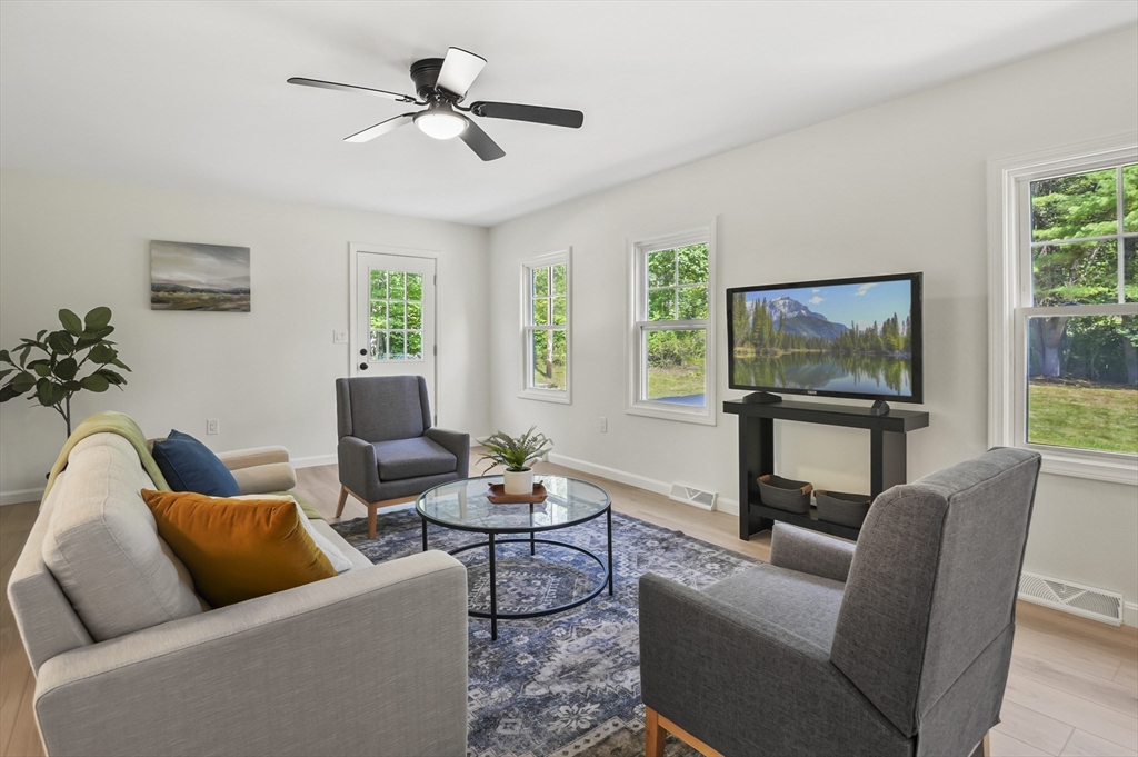 128 Dana Road Oxford, MA 01540 - Photo 4 of 23 a living room with furniture a flat screen tv and a large window