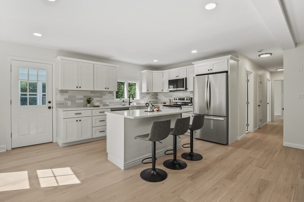128 Dana Road Oxford, MA 01540 - Photo 9 of 23 a kitchen with white cabinets and stainless steel appliances
