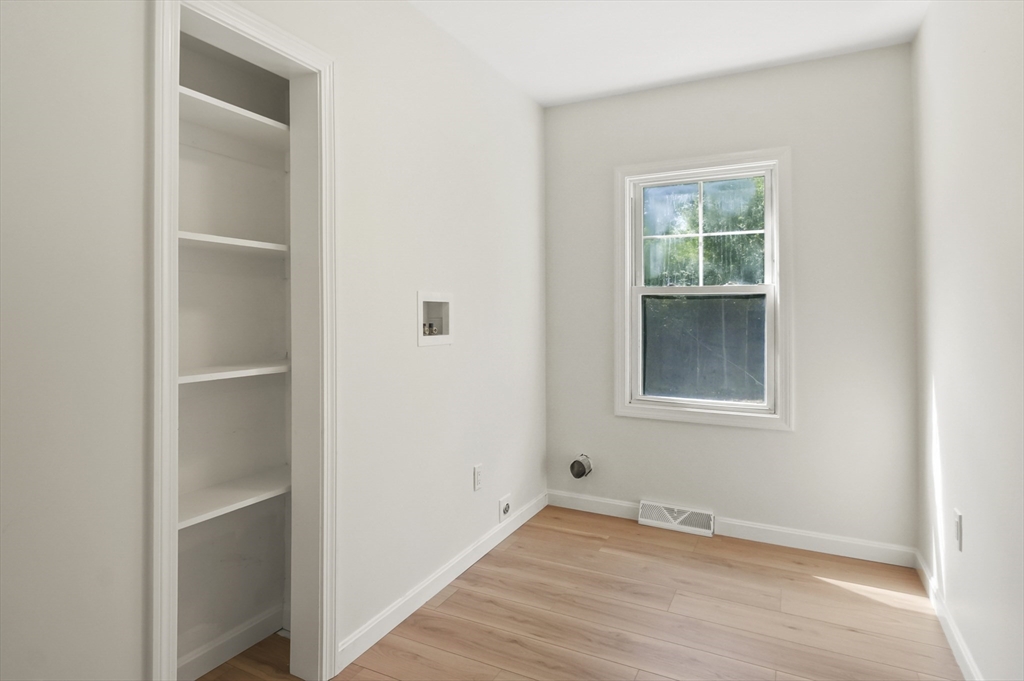 128 Dana Road Oxford, MA 01540 - Photo 10 of 23 a view of an empty room with wooden floor and a window