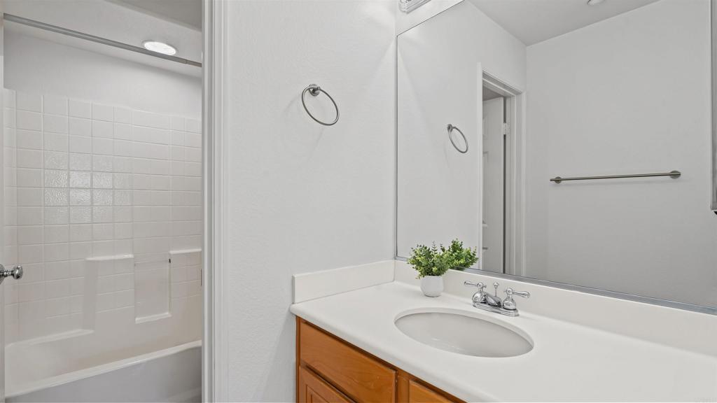 1280 Haglar Way, Unit 2 Chula Vista, CA 91913 - Photo 23 of 35 a bathroom with a granite countertop sink and a mirror