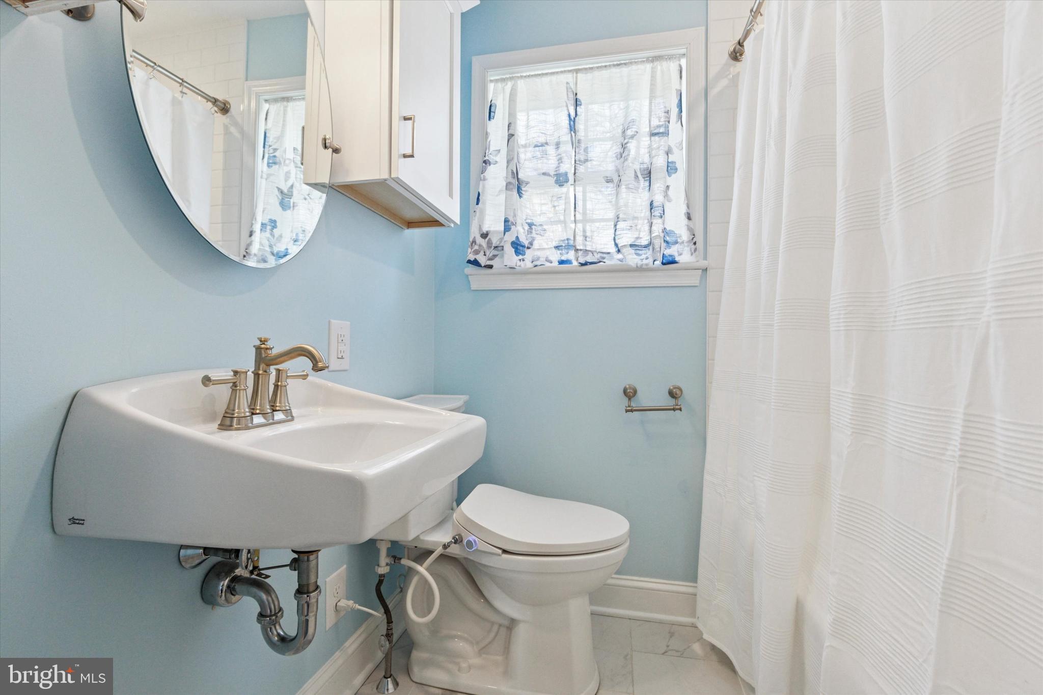 326 Maple Avenue Glenside, PA 19038 - Photo 16 of 25 a bathroom with a toilet a sink and a mirror