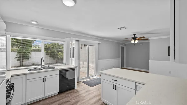 a kitchen with stainless steel appliances a sink stove and refrigerator