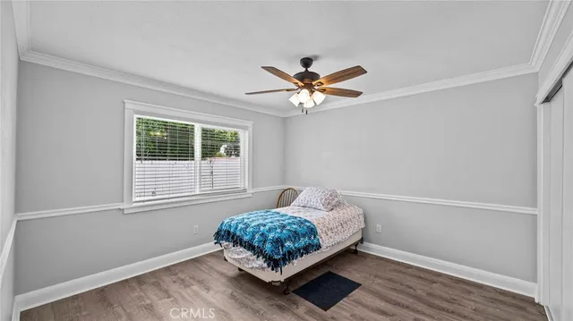 a bedroom with a bed and a ceiling fan