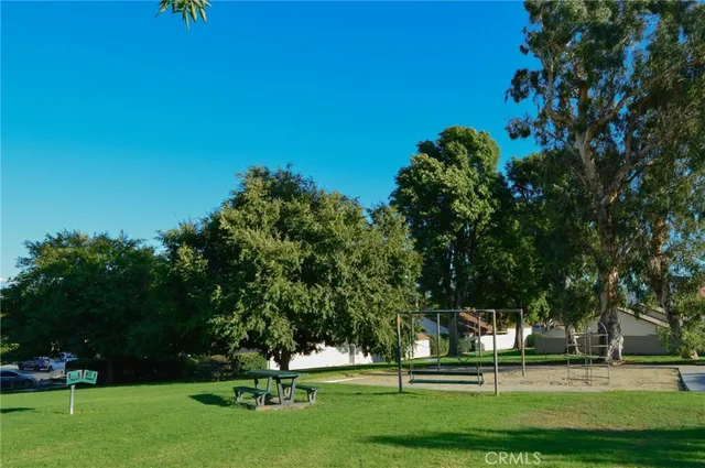 a green field with lots of trees