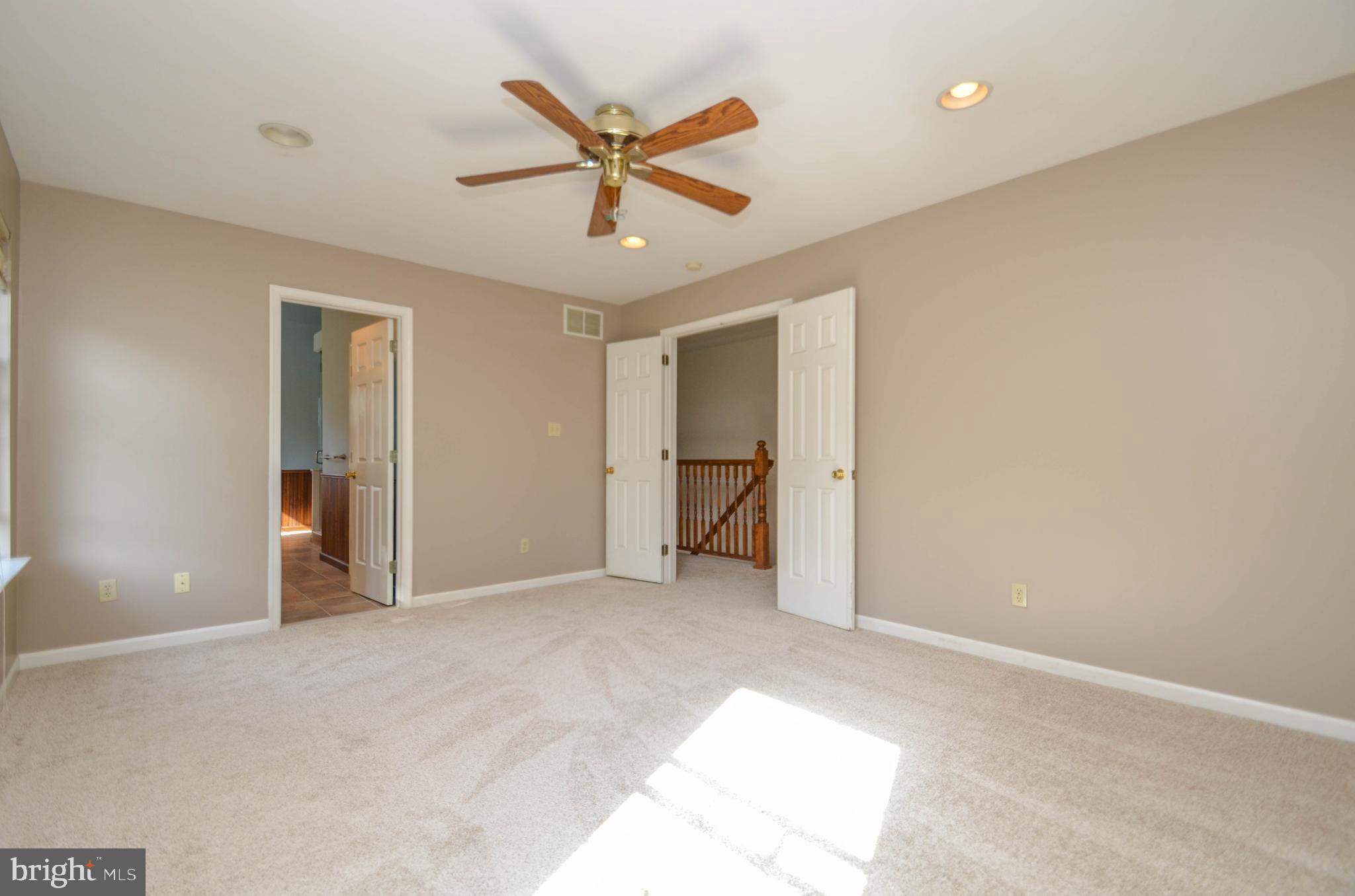 5382 Princeton Road Macungie, PA 18062 - Photo 12 of 33 a view of a livingroom with a ceiling fan and wooden floor