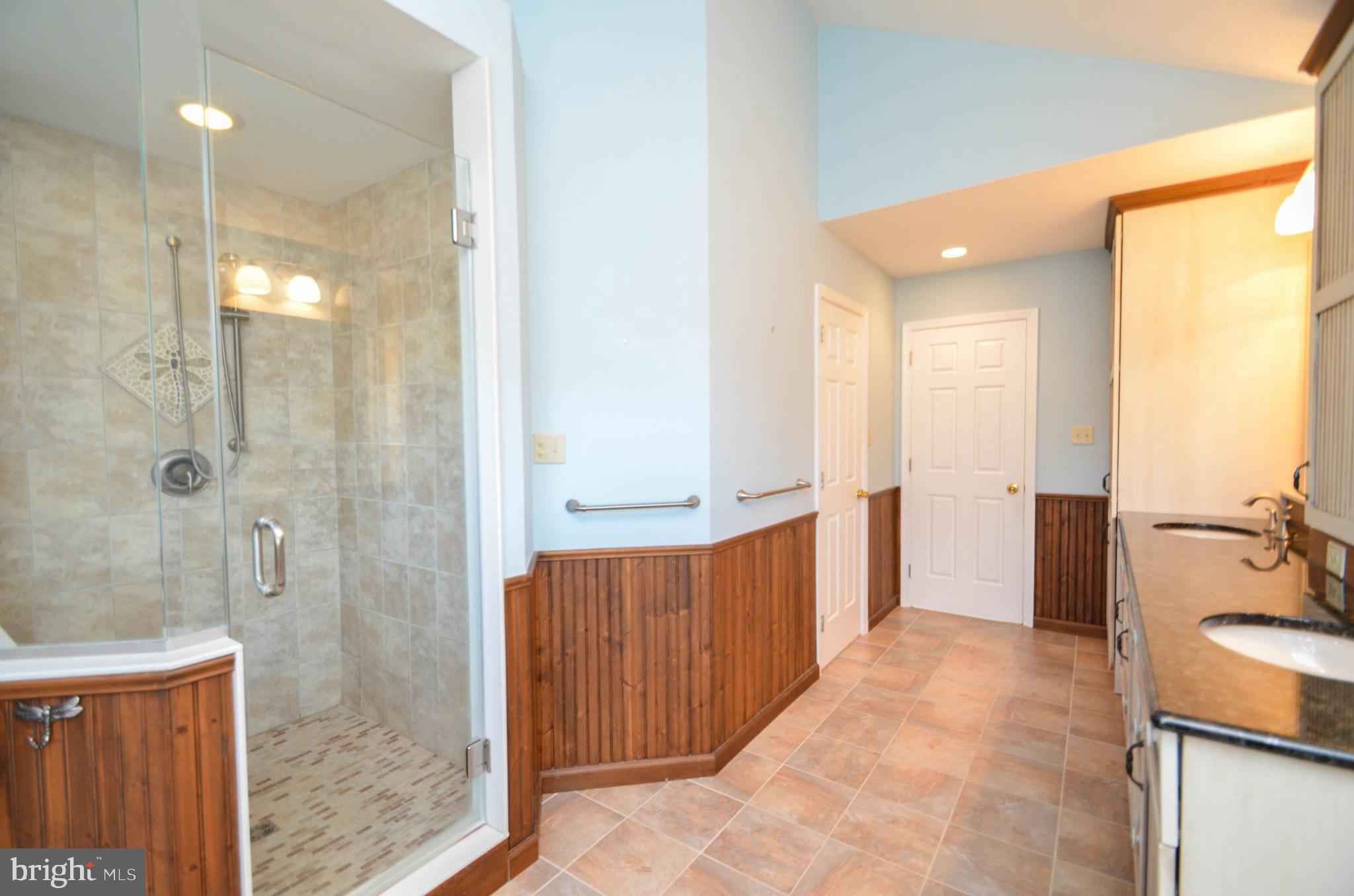 5382 Princeton Road Macungie, PA 18062 - Photo 15 of 33 a bathroom with a glass door shower a sink and a mirror