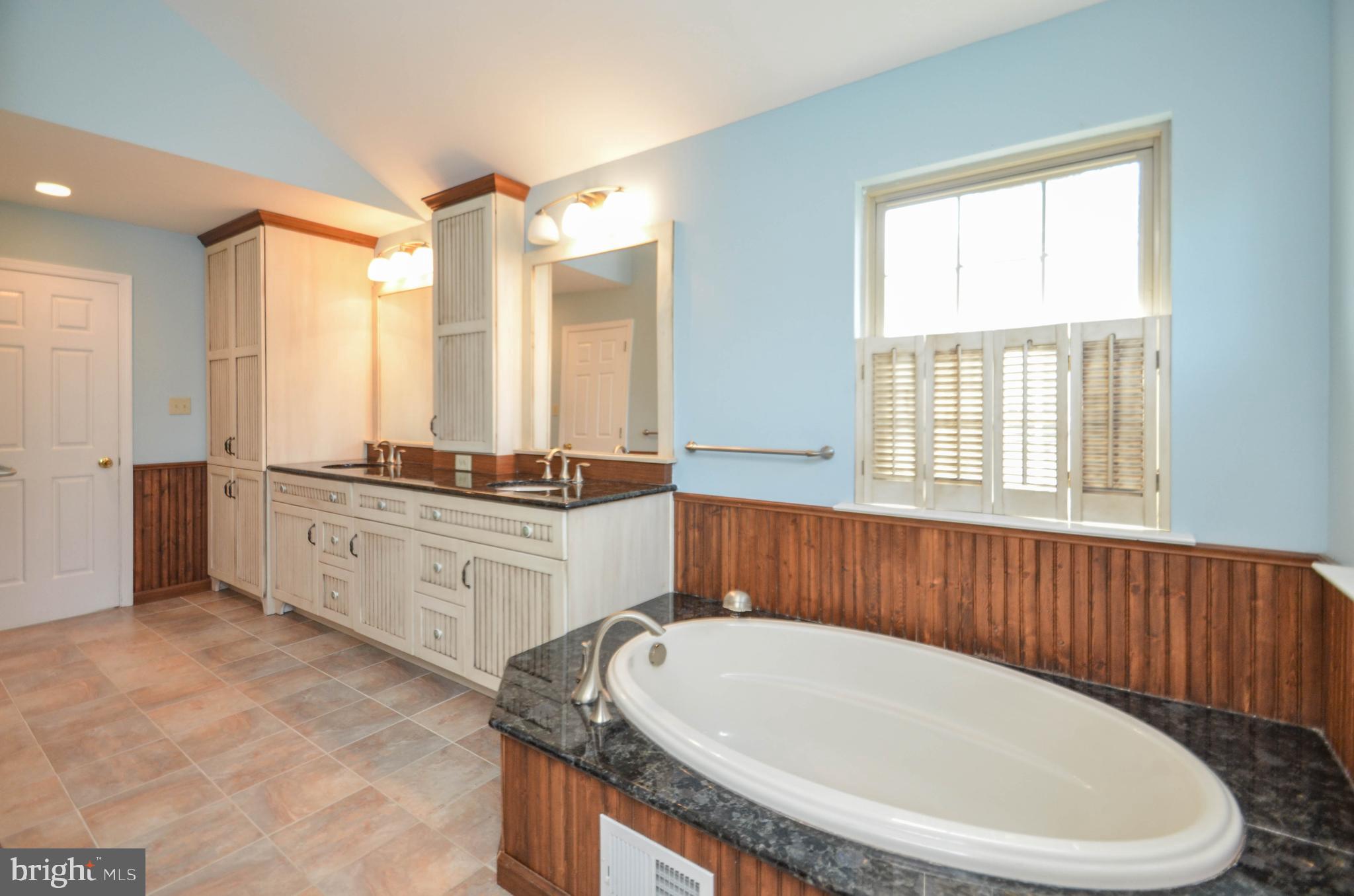 5382 Princeton Road Macungie, PA 18062 - Photo 16 of 33 a spacious bathroom with a granite countertop tub sink and mirror