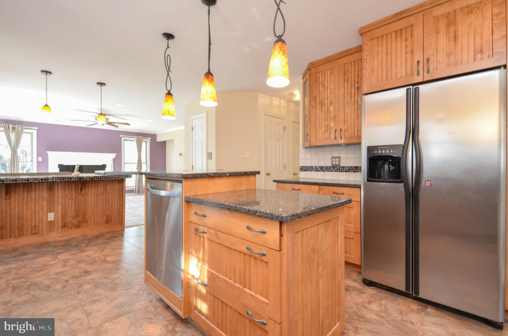5382 Princeton Road Macungie, PA 18062 - Photo 6 of 33 a kitchen with stainless steel appliances granite countertop a sink a counter space and a view of living room