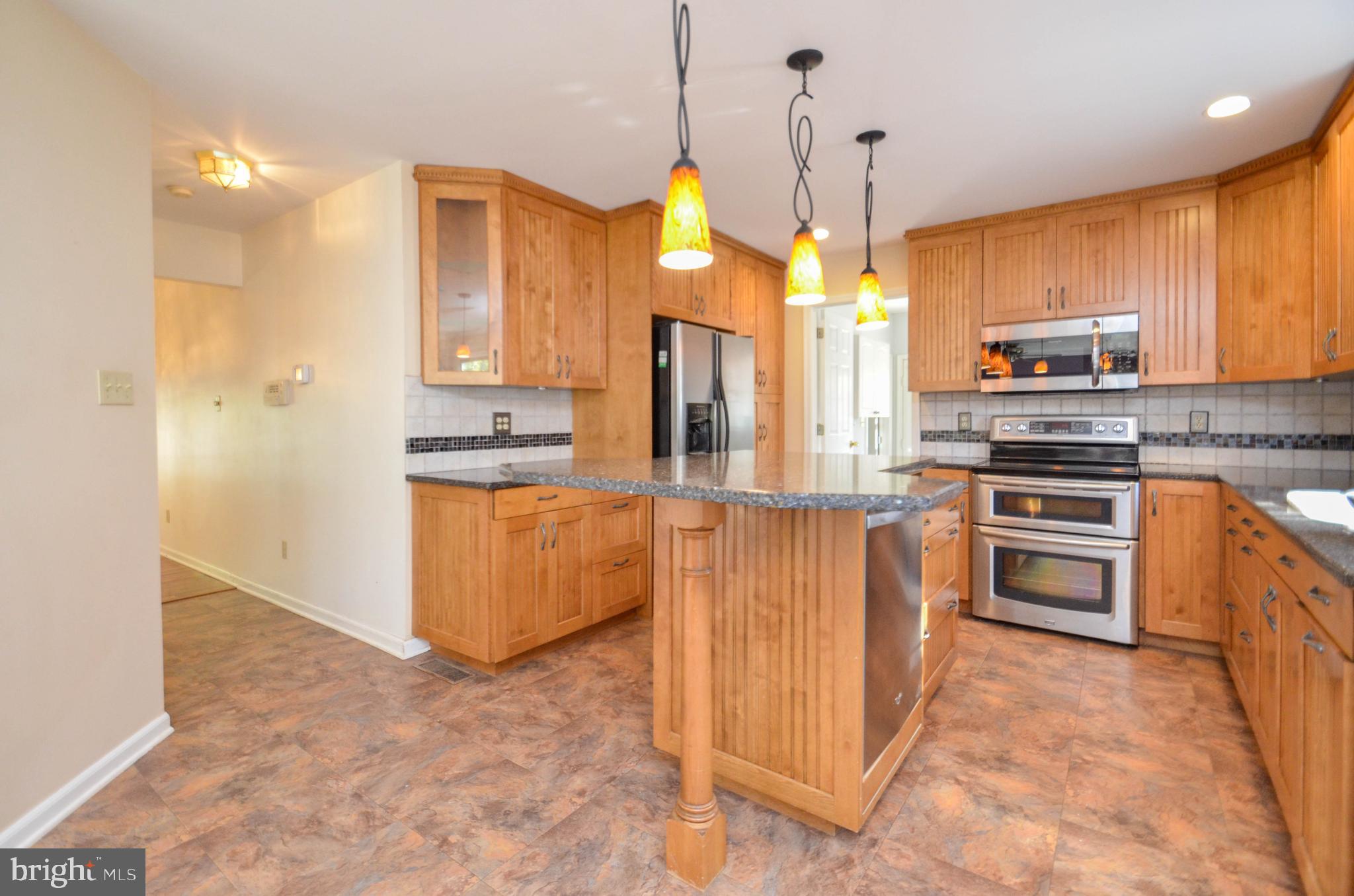 5382 Princeton Road Macungie, PA 18062 - Photo 7 of 33 a kitchen with stainless steel appliances granite countertop a stove a sink a refrigerator and a oven