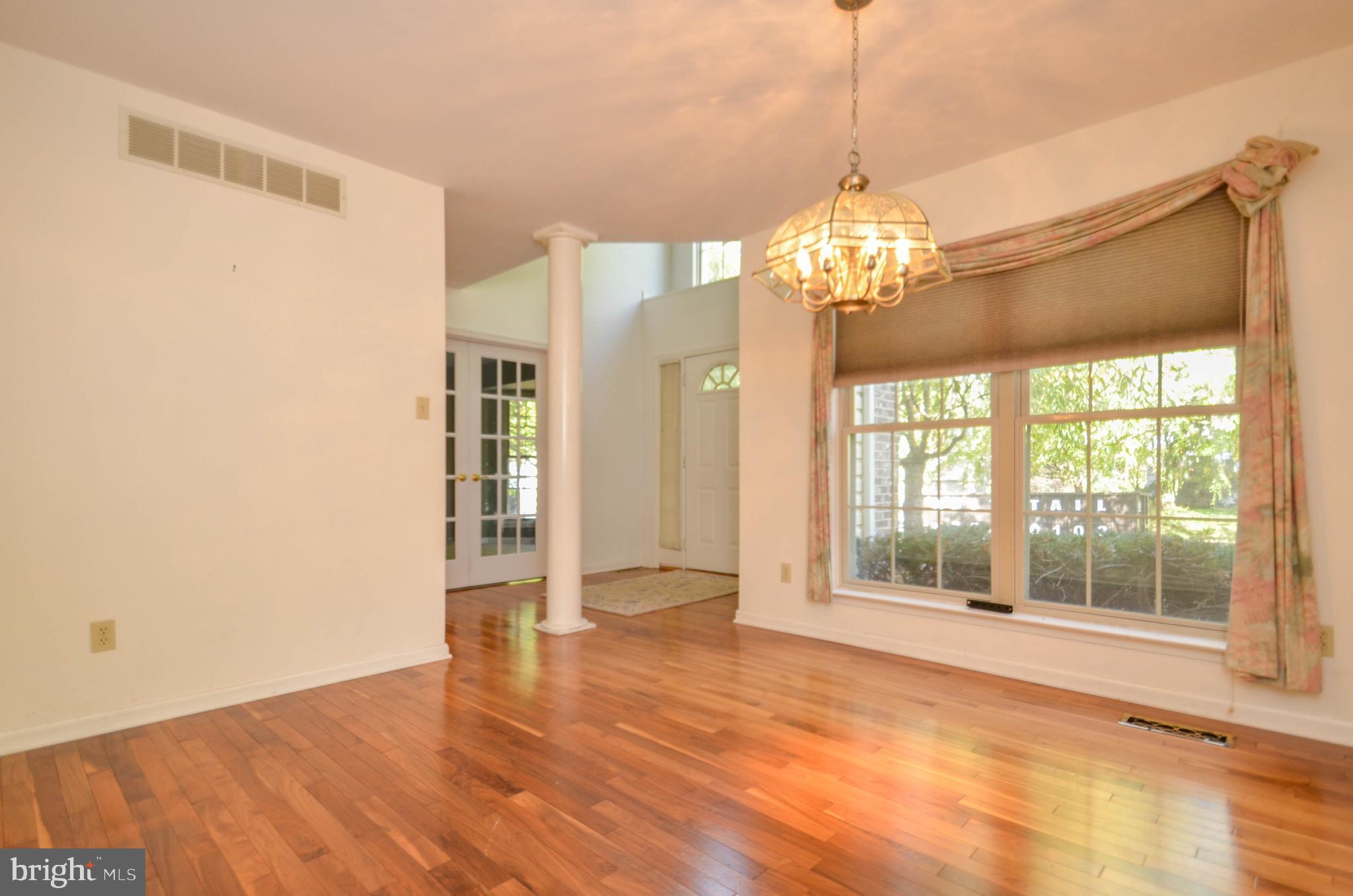 5382 Princeton Road Macungie, PA 18062 - Photo 9 of 33 a view of a big room with wooden floor chandeliers and kitchen view
