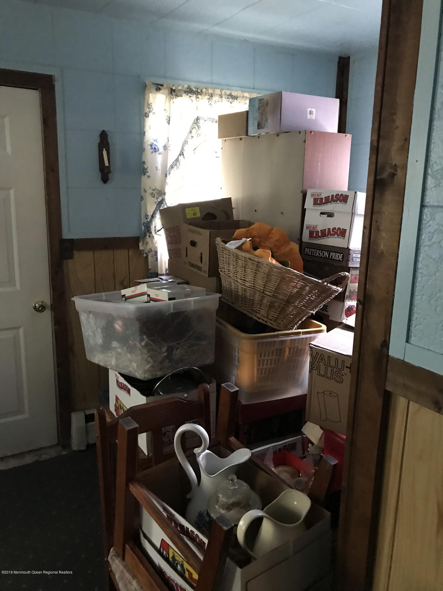 70 Pinewood Road Howell, NJ 07731 - Photo 14 of 22 a room with a stove and a wooden floor