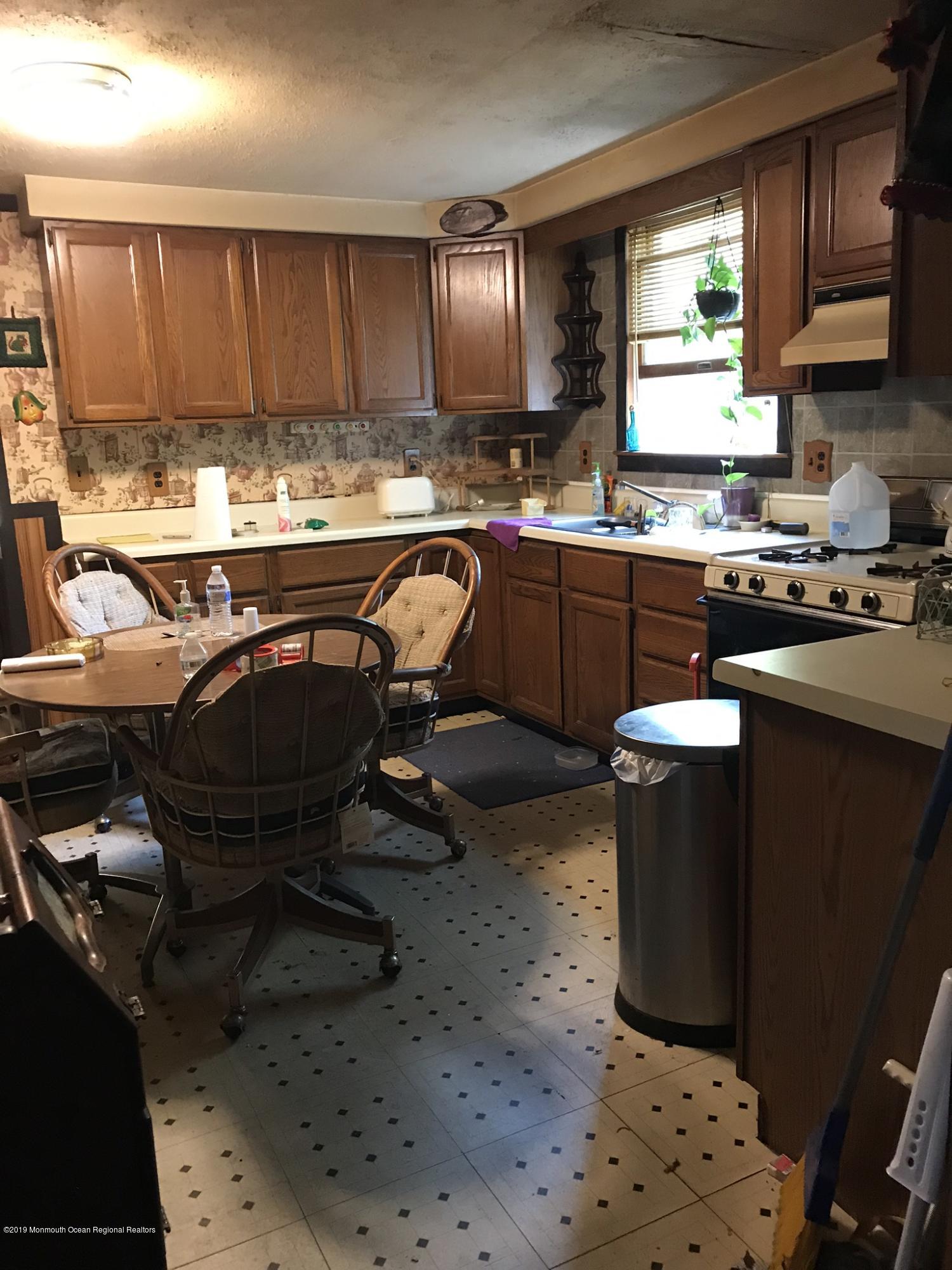 70 Pinewood Road Howell, NJ 07731 - Photo 3 of 22 a kitchen with granite countertop a sink a stove and wooden cabinets