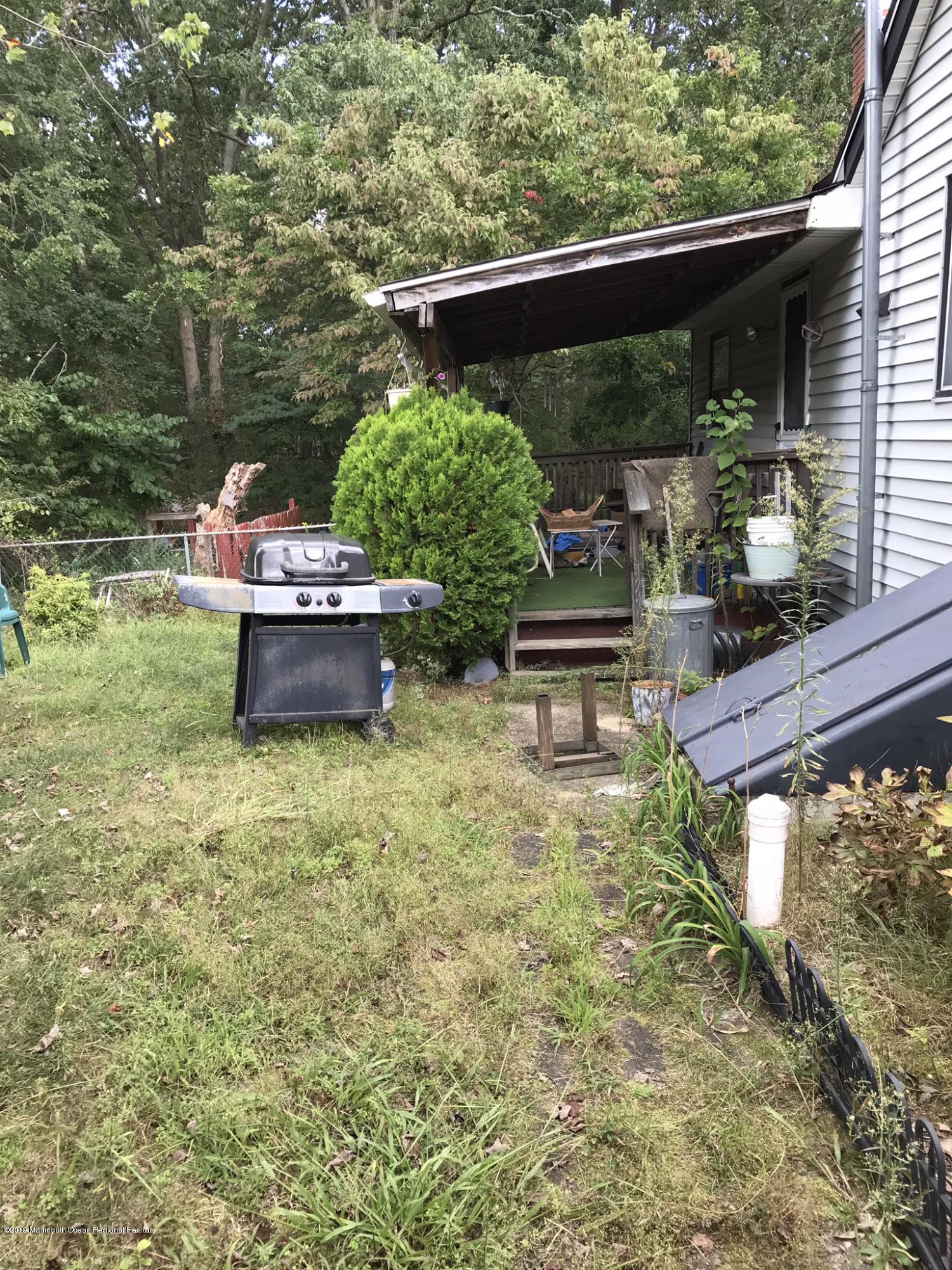 70 Pinewood Road Howell, NJ 07731 - Photo 21 of 22 a backyard of a house with outdoor seating