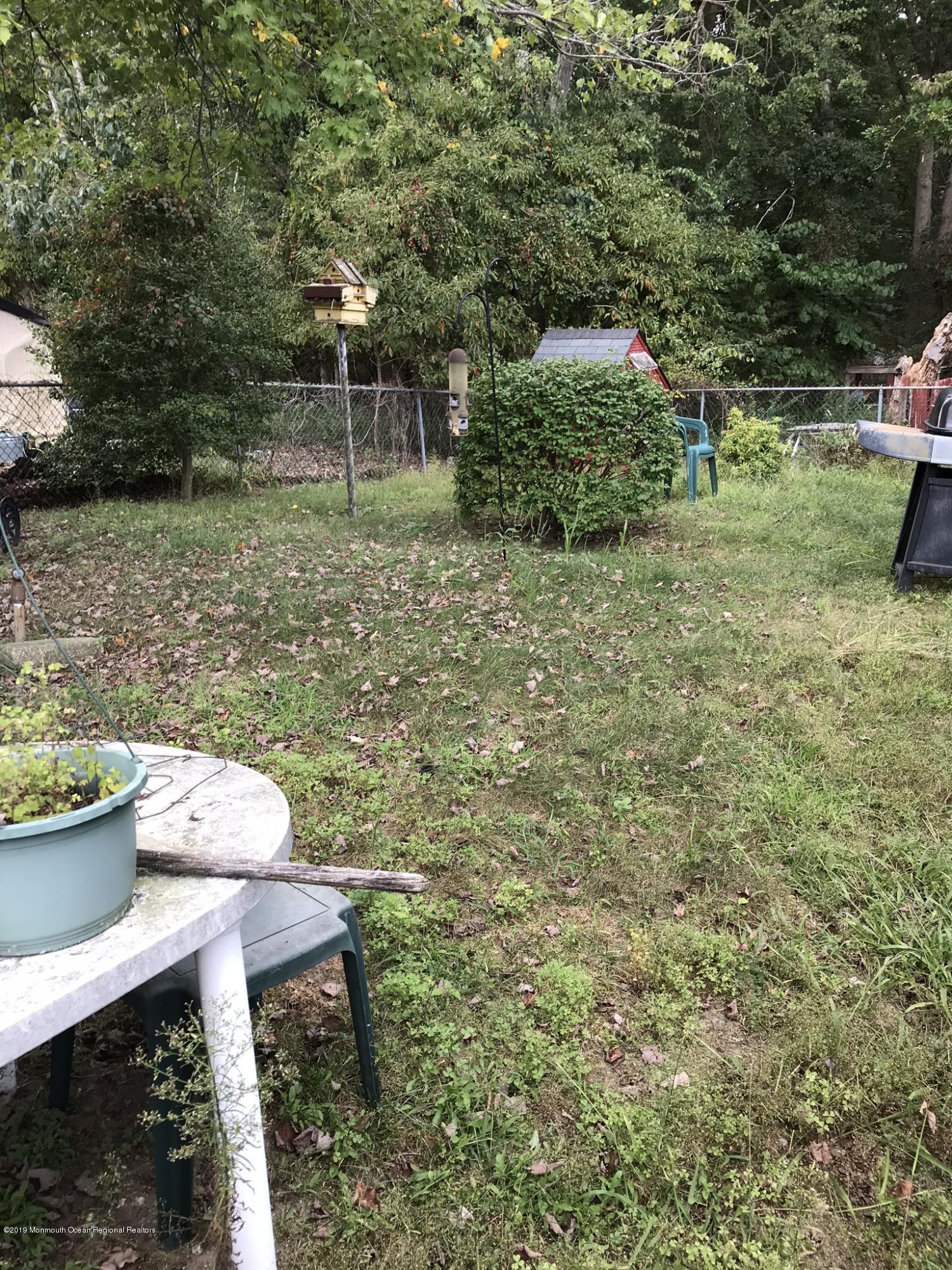 70 Pinewood Road Howell, NJ 07731 - Photo 22 of 22 a backyard of a house with fountain table and chairs
