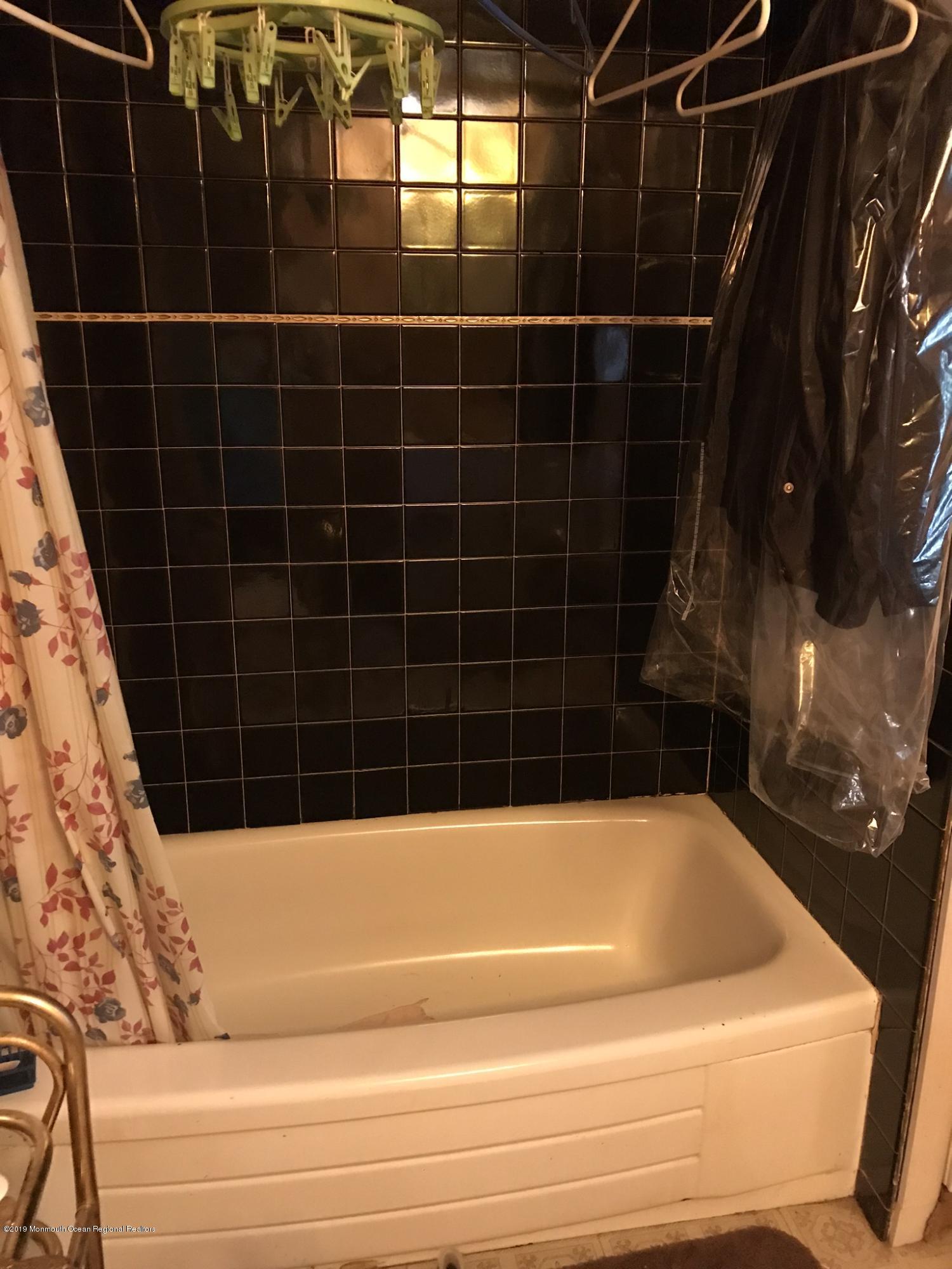 70 Pinewood Road Howell, NJ 07731 - Photo 9 of 22 a bathroom with a bathtub