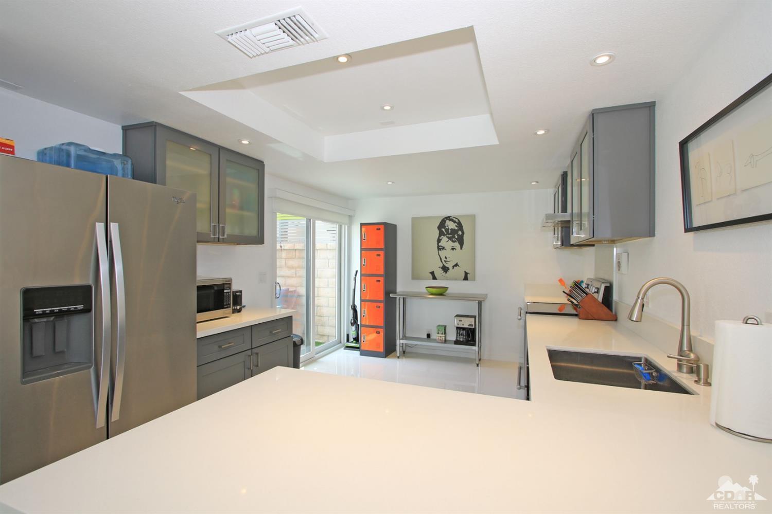 6012 East Driver Road Palm Springs, CA 92264 - Photo 12 of 47 a kitchen with stainless steel appliances a refrigerator sink and microwave