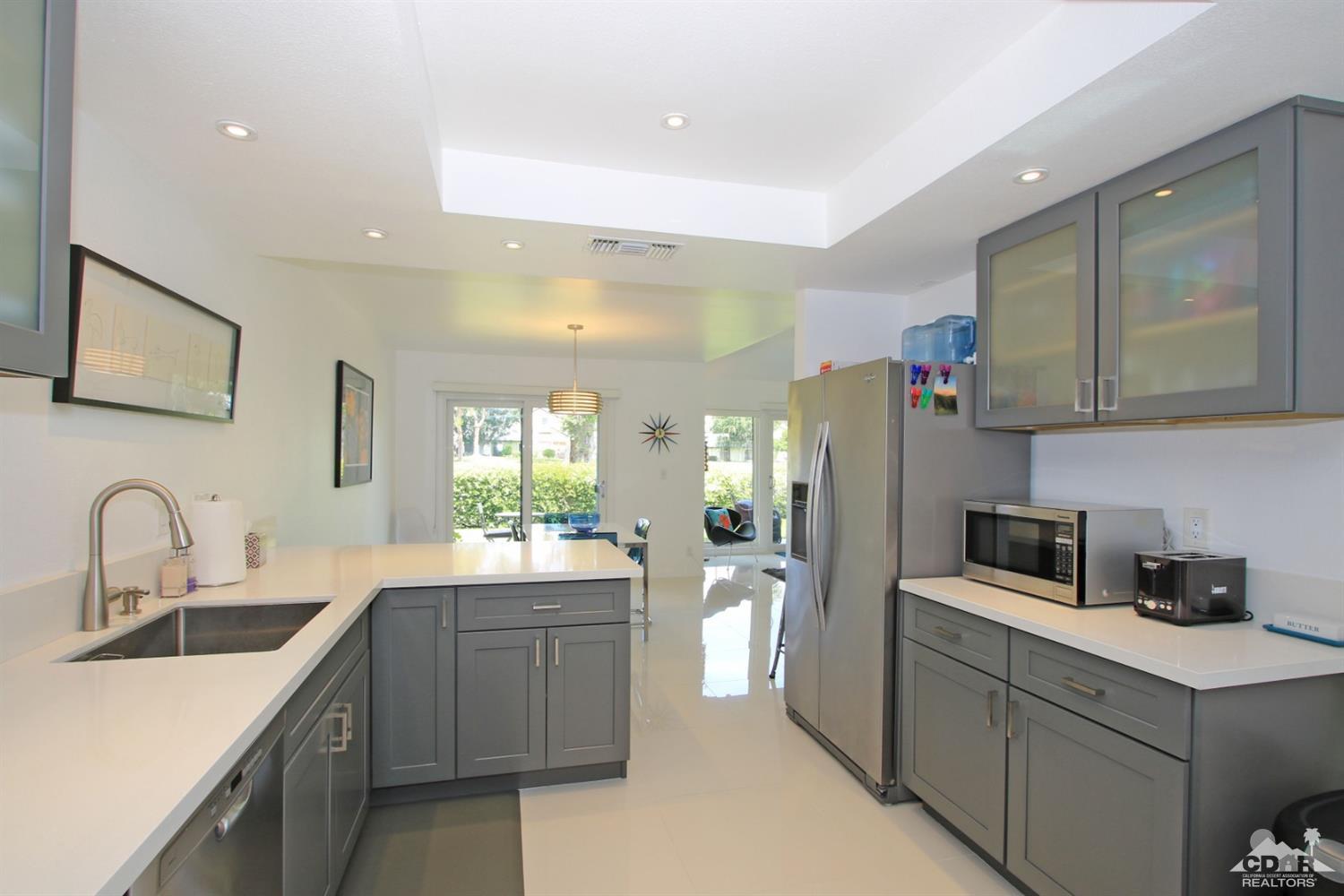 6012 East Driver Road Palm Springs, CA 92264 - Photo 14 of 47 a kitchen with sink a refrigerator and cabinets