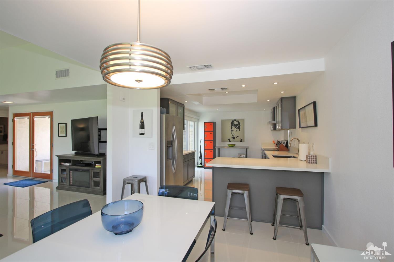 6012 East Driver Road Palm Springs, CA 92264 - Photo 21 of 47 a kitchen with a dining table and chairs