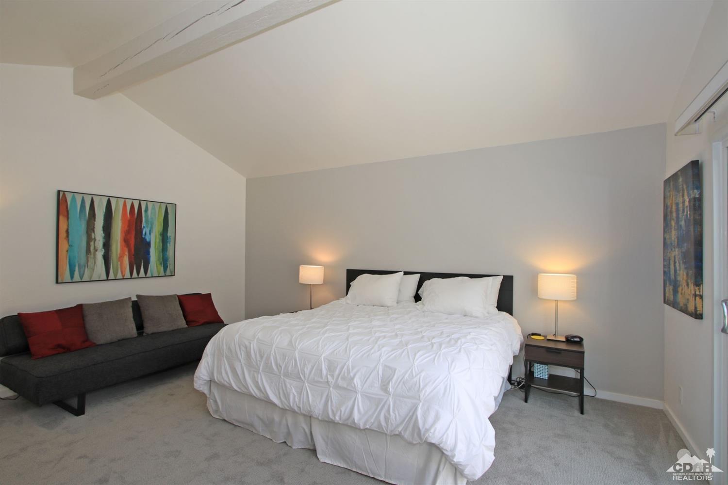 6012 East Driver Road Palm Springs, CA 92264 - Photo 22 of 47 a bedroom with a bed and a couch